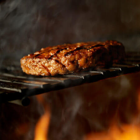 Burger cooking on a grill